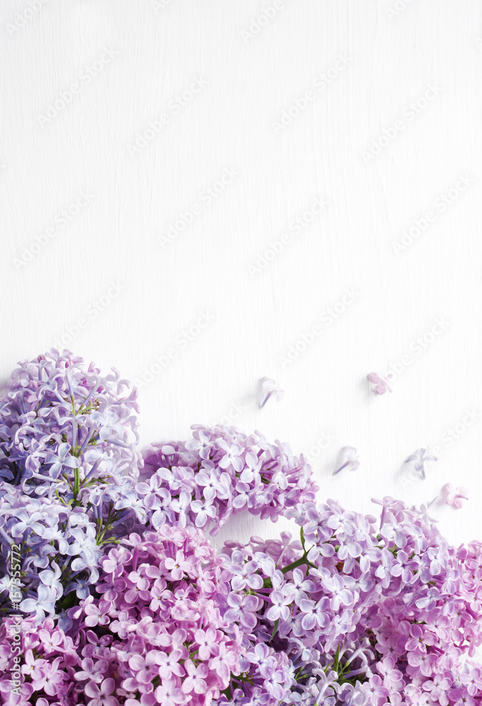 Lilac bouquet of flowers on a white wooden background. Spring romantic bouquet. Lilac bouquet of flowers on a white wooden background. Spring romantic bouquet.