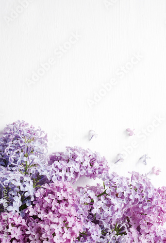 Lilac bouquet of flowers on a white wooden background. Spring romantic bouquet.