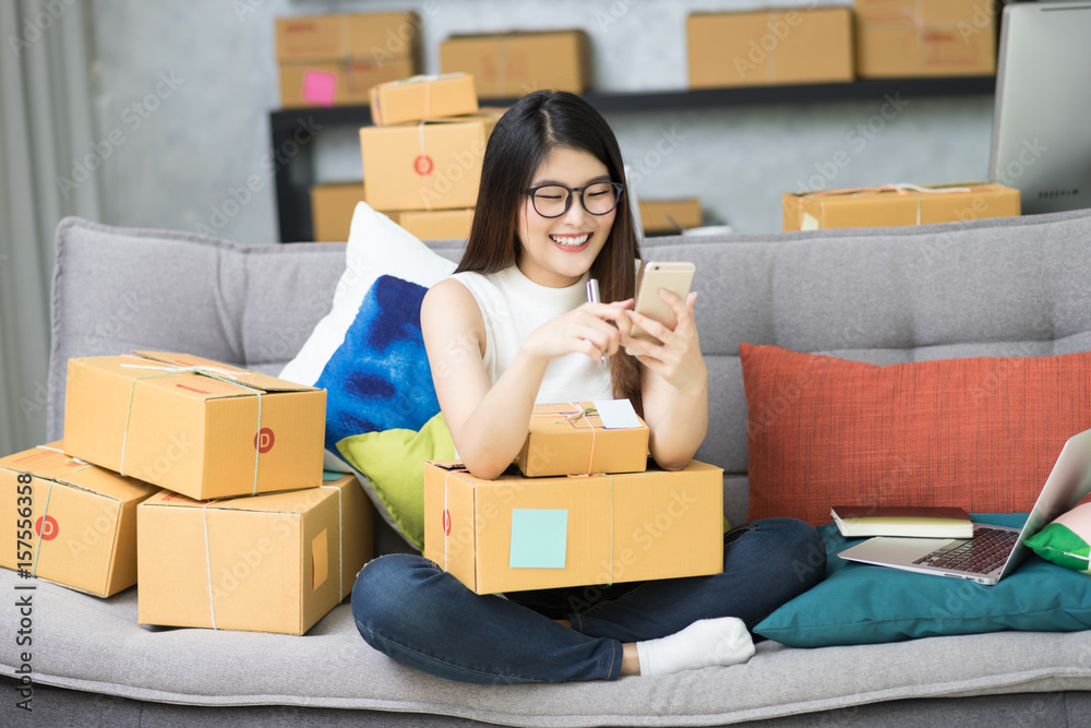 Charming beautiful asian teenager owner business woman work at home online shopping,writing the order preparing package product office equipment, entrepreneur and alpha generation life style concept Charming beautiful asian teenager owner business woman work at home online shopping,writing the order preparing package product office equipment, entrepreneur and alpha generation life style concept