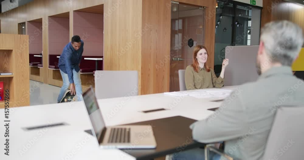 Entrepreneur skateboarding in to an office meeting Entrepreneur skateboarding in to an office meeting