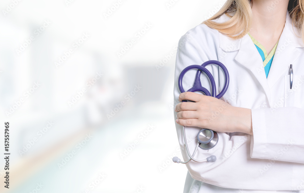 female medical professional holding a purple stethoscope in her hand female medical professional holding a purple stethoscope in her hand