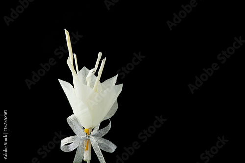 Kind of wood flower on black background with copy space; to be placed on the site of cremation in Thailand (Dok Mai Jan)