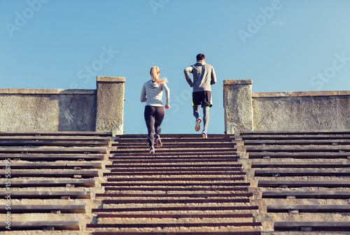 couple running upstairs on stadium
