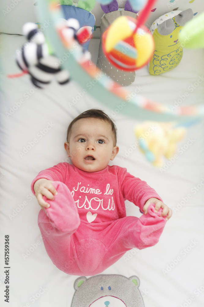cute baby laughing and looking up to his toys in his crib cute baby laughing and looking up to his toys in his crib