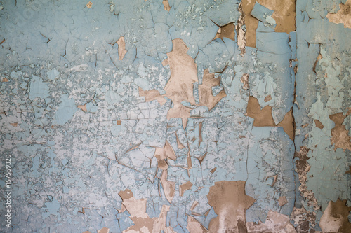 blue peeling paint on aged cement wall texture