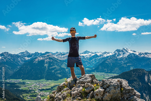 Man celebrating nature and reaching the summit
