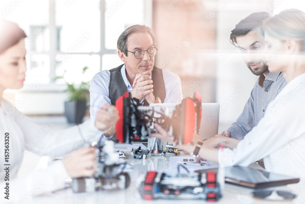 Professional team sitting around table in office Professional team sitting around table in office