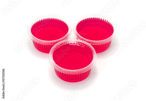 Red jelly in cup on white background.