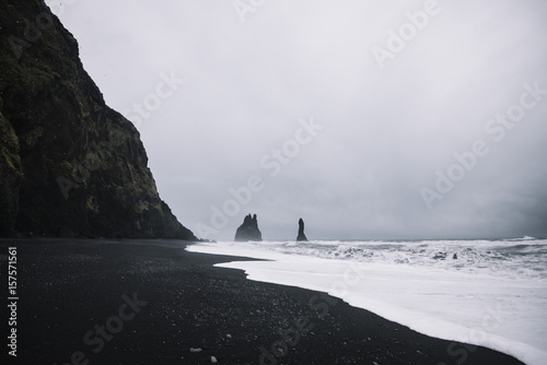Beautiful black sand beach in Iceland with basalt formations and view on Atlantic ocean