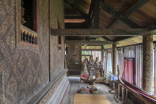 Interior wall decoration with gilded black lacquer or Lai Rod Nam inside Ho Trai or the Buddhist scriptures (Tripitaka or Pali Canon) library at Wat Mahathat Temple in Yasothon, Thailand
