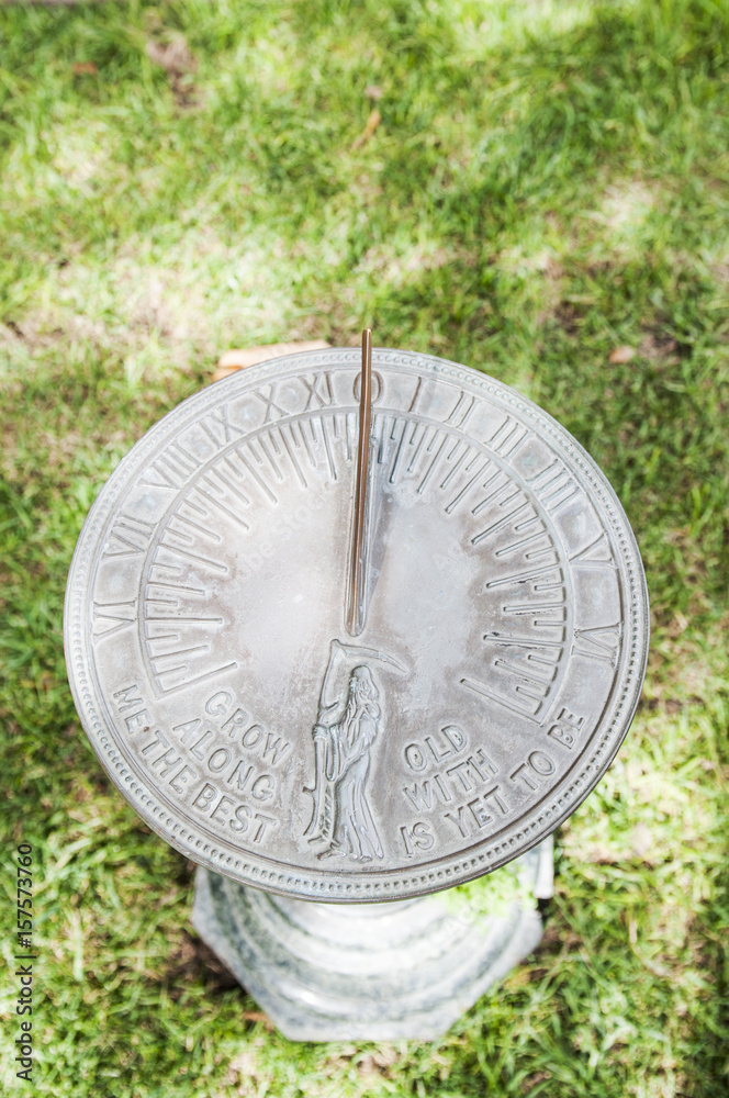 Stone sundial on grass 