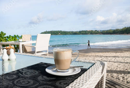 Shot of Latte Coffee cup on beautiful  table by the beach.