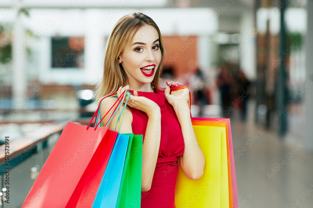 Cute girl with red lips standing with shopping bags Cute girl with red lips standing with shopping bags