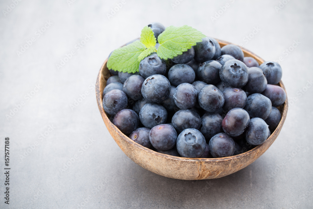 Fresh blueberries natural coconut in a bowl on a gray background. Fresh blueberries natural coconut in a bowl on a gray background.
