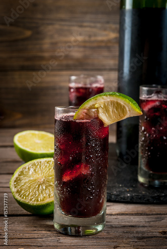 Traditional Spanish alcoholic drink, cocktail, Calimocho. With wine, cola, lime juice and ice. Decorated with pieces of lime. Copy space photo