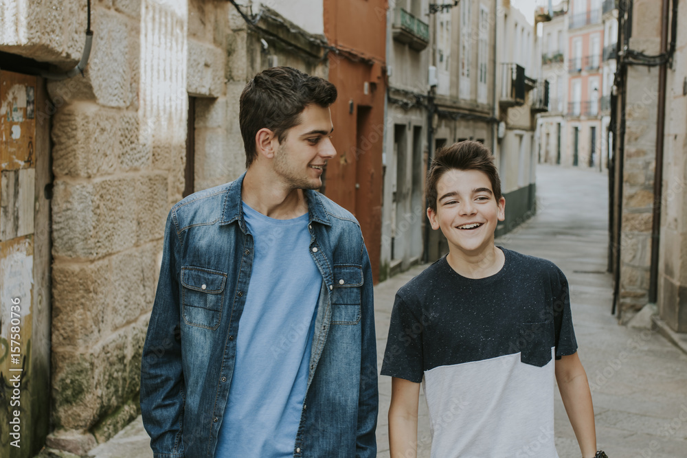 young smiling walking down the street