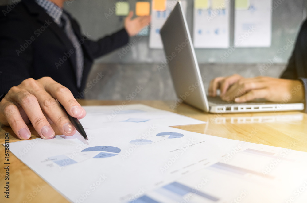 © Freedomz - Business executive pointing graph presentation to colleagues in office, during meeting, explaining, consultation