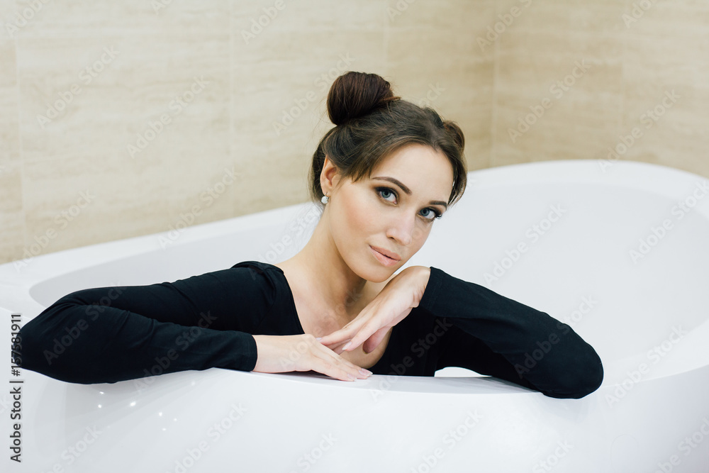 Woman in a black bodysuit in the bathroom Woman in a black bodysuit in the bathroom