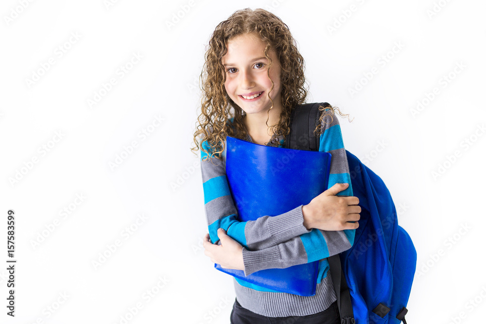Fototapeta premium girl of 9 years in a school uniform poses in studio.