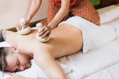 man engaged in Ayurvedic spa treatment photo