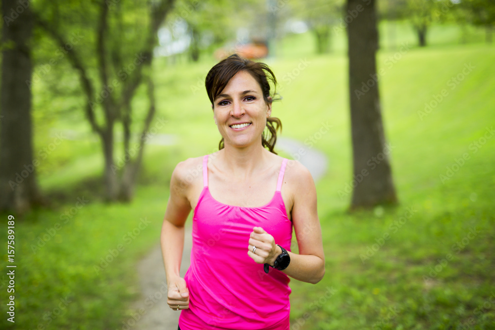 Fototapeta premium portrait of a woman jogging outdoors