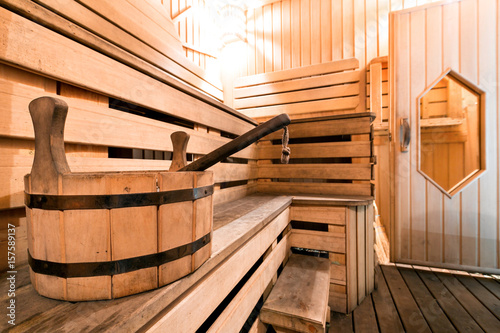 Empty wooden sauna room with ladle, bucket ready to be used