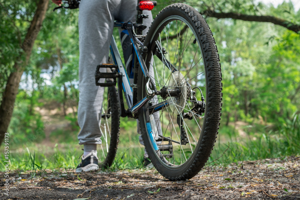 Relax on a mountain bike ride along the forest path. Sports and the concept of active life in the summer. Horizontal frame Relax on a mountain bike ride along the forest path. Sports and the concept of active life in the summer. Horizontal frame