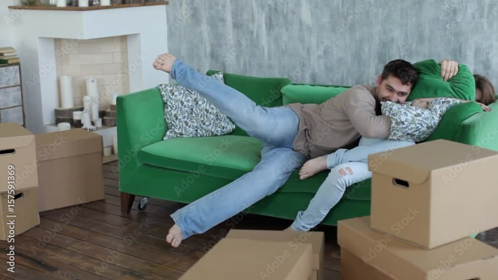 Happy Couple Fighting by Cushions, Boxes Moving to New Apartment Happy Couple Fighting by Cushions, Boxes Moving to New Apartment