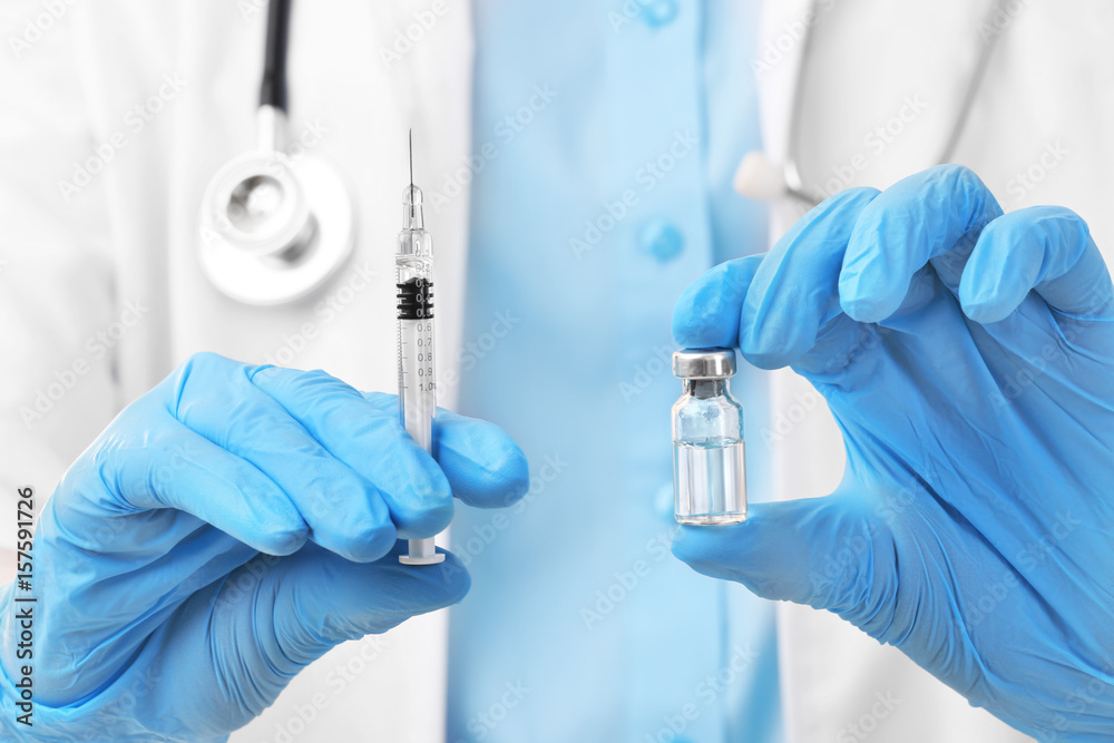 Doctor with syringe and medicine, closeup Doctor with syringe and medicine, closeup