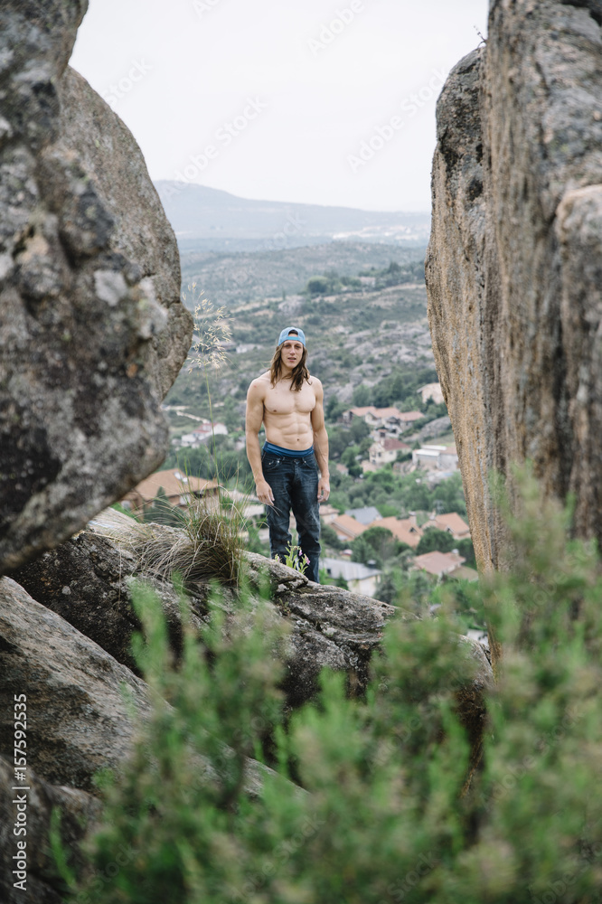 Climbing man between rocks