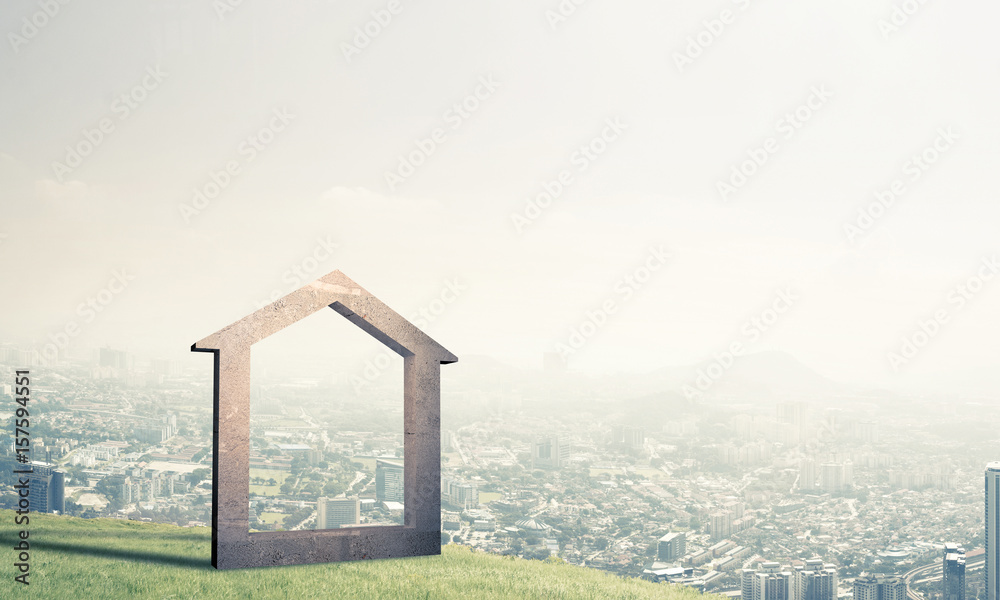 Conceptual image of concrete home sign on hill and natural lands Conceptual image of concrete home sign on hill and natural lands