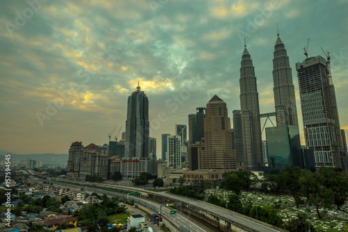 A cloudy sunrise in Kuala Lumpur  the capital of Malaysia. Its modern skyline is dominated by the 451m tall KLCC  a pair of glass and steel clad skyscrapers.