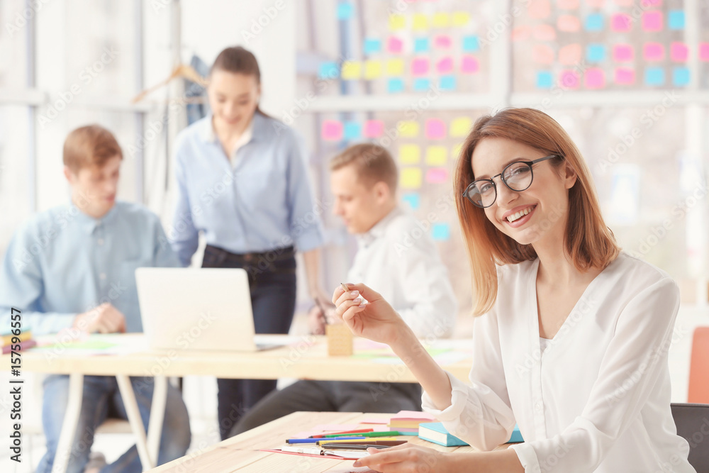 Fototapeta premium Beautiful young woman working in office