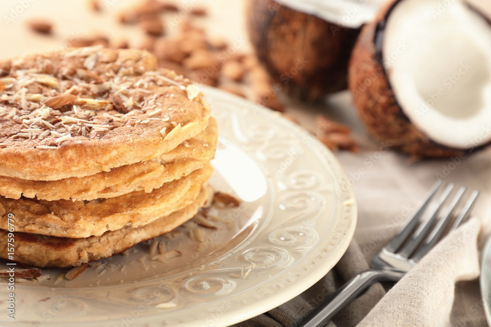 Delicious coconut pancakes decorated with almond shavings, close up