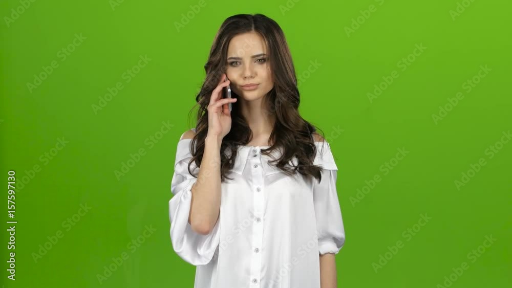 Brunette picks up the phone, dials the number she wants and rings. Green screen Brunette picks up the phone, dials the number she wants and rings. Green screen