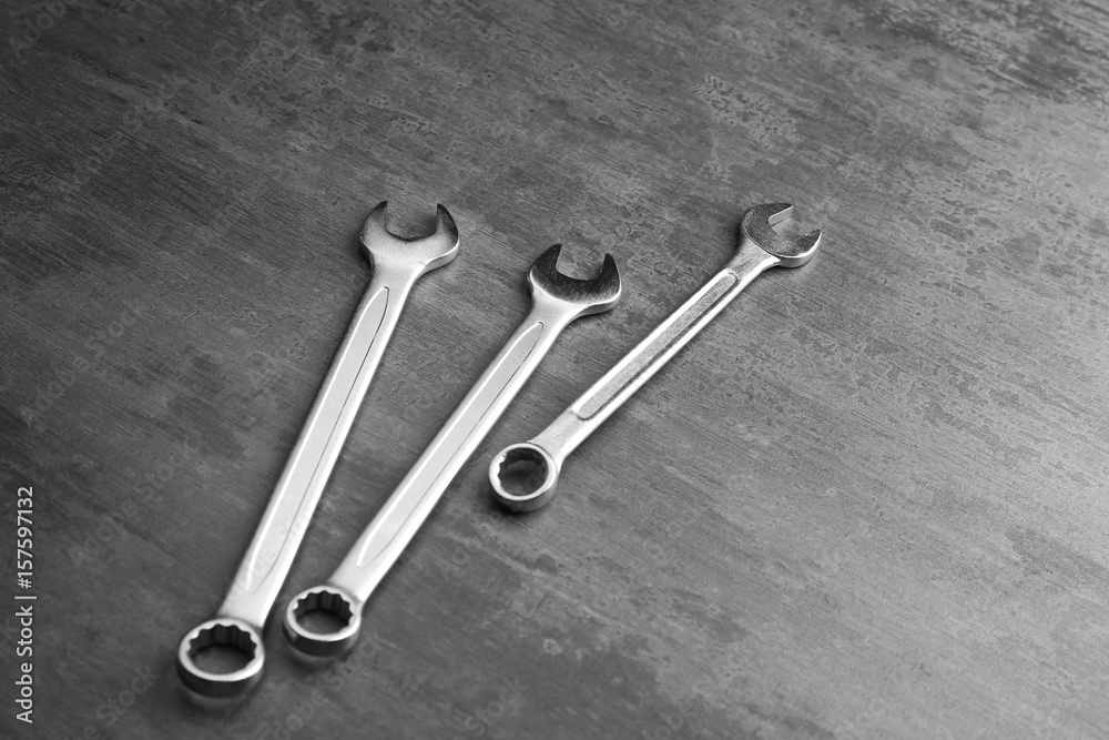 Combination wrenches for car repair on grey table Combination wrenches for car repair on grey table