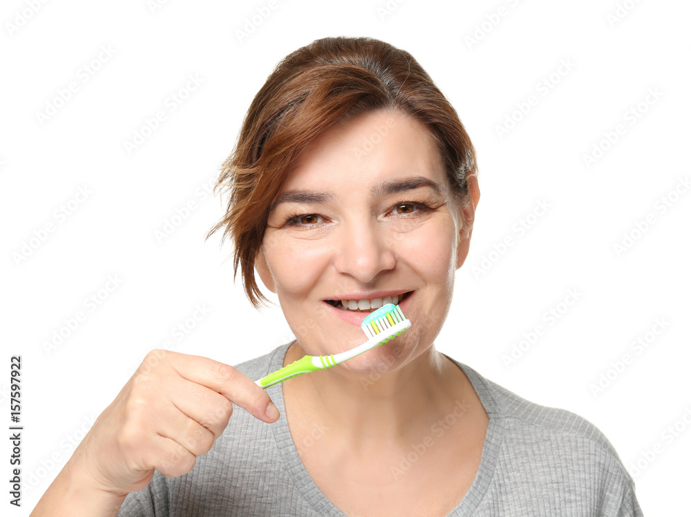 Senior woman cleaning teeth on white background Senior woman cleaning teeth on white background