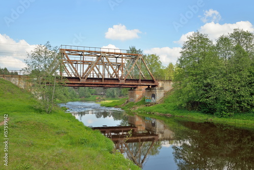 Railway bridge across the river Oredezh at Vyritsa in the summer