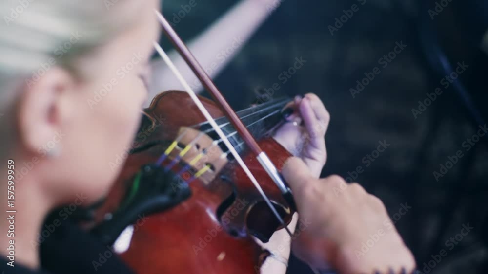 Female violinist playing violin. Close up of woman playing violin in orchestra concert. Violinist girl playing classical music instrument. Violin player playing music. Woman play violin Female violinist playing violin. Close up of woman playing violin in orchestra concert. Violinist girl playing classical music instrument. Violin player playing music. Woman play violin