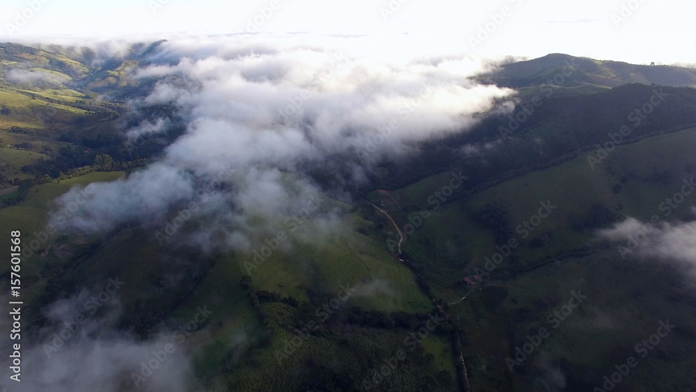 Aerial View of clouds in a Mountain Valley