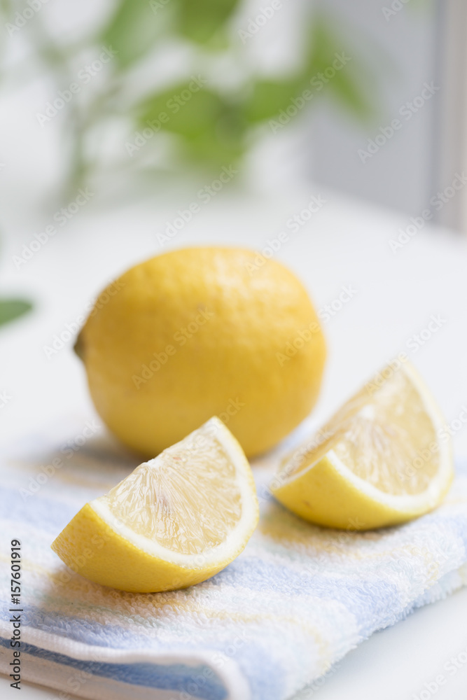 Yellow Lemon with slice closeup on the table. Yellow Lemon with slice closeup on the table.
