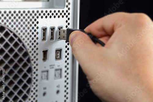 Hand connecting USB to the computer