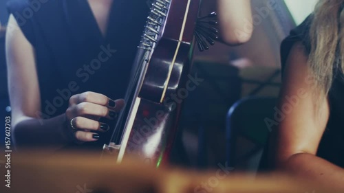 National Ukrainian musical instrument. Pandora music player. Kobza Ukrainian stringed musical instrument. Close up of orchestra playing bandura. Bandura player music. Traditional musical instrument photo