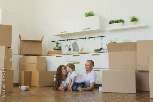 moving to a new home. Happy family with cardboard boxes