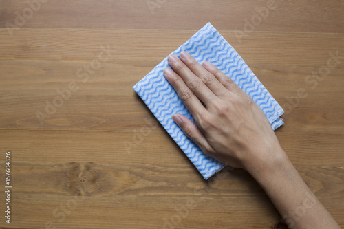 Cleaning table by woman hand
