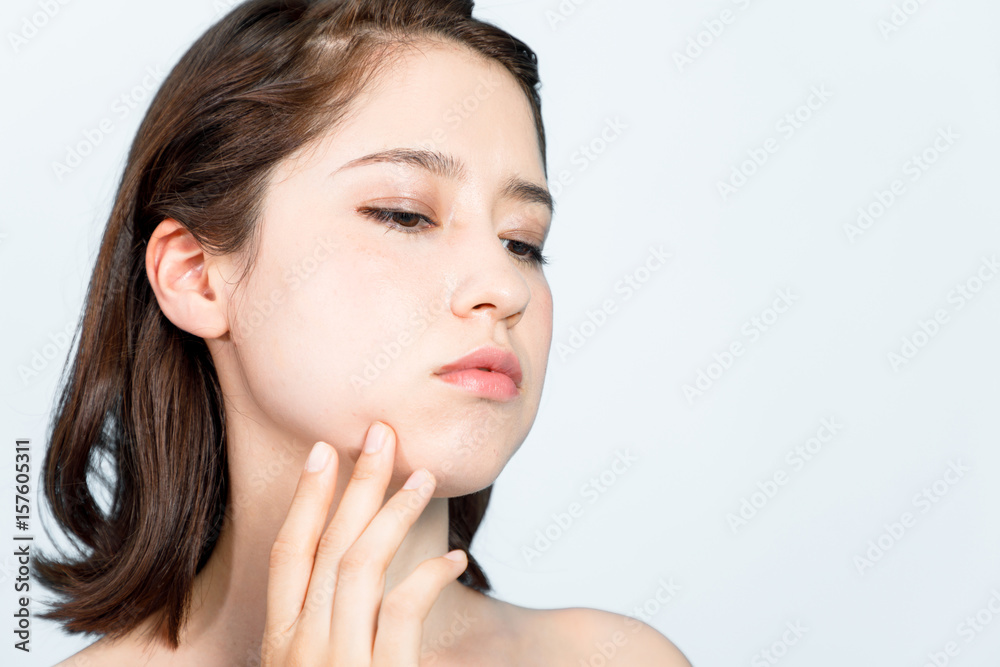 young girl who checks her skin. skin care concept. acne treatment.