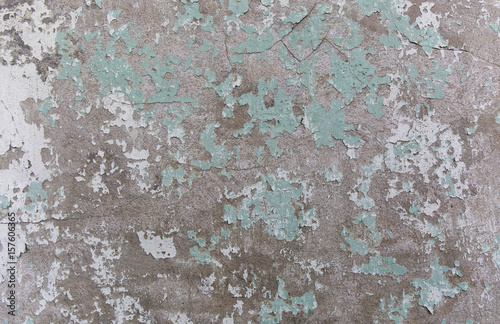 Old painted wall. Green and damage surface. Peeling paint background. Stone demaged backdrop.