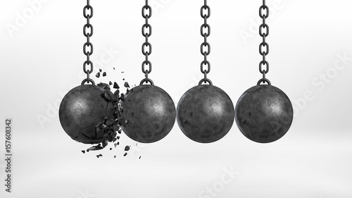 3d rendering of a set of four black iron wrecking balls handing from their chains where one ball is broken.