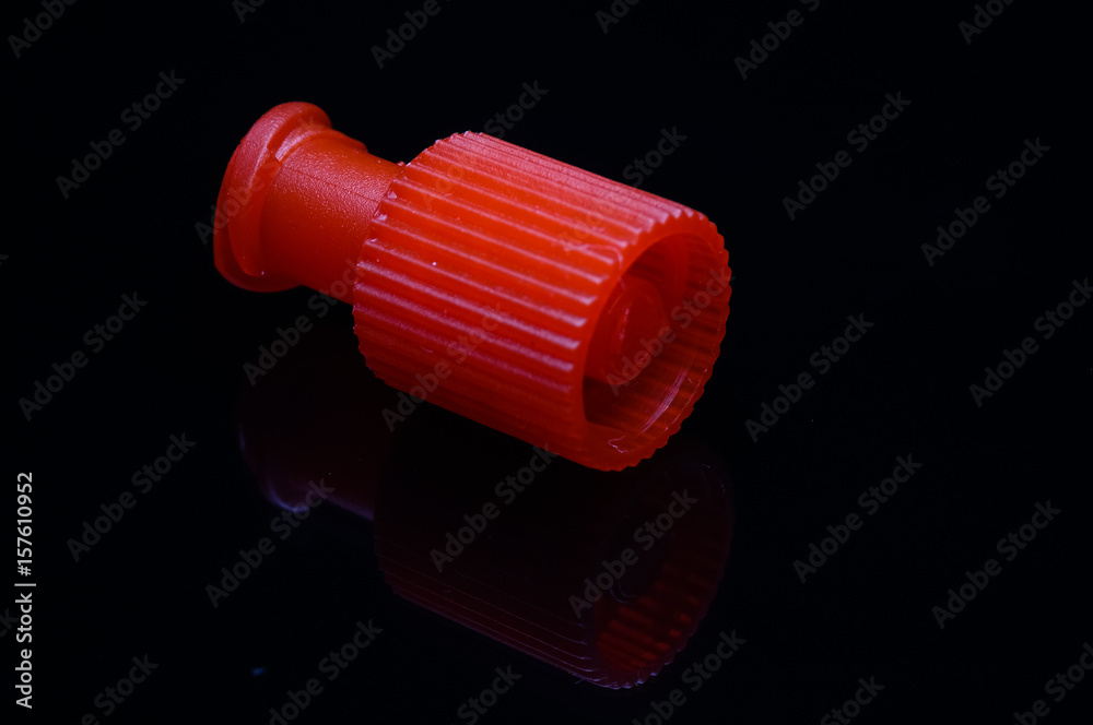 close up of heparin cap isolated on black