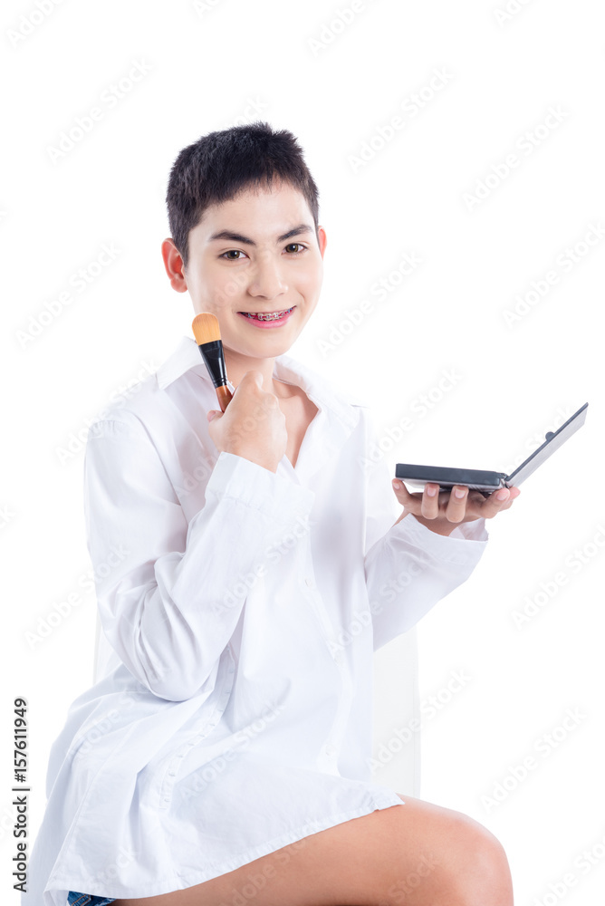 Young asian boy applying brush on over white background Young asian boy applying brush on over white background
